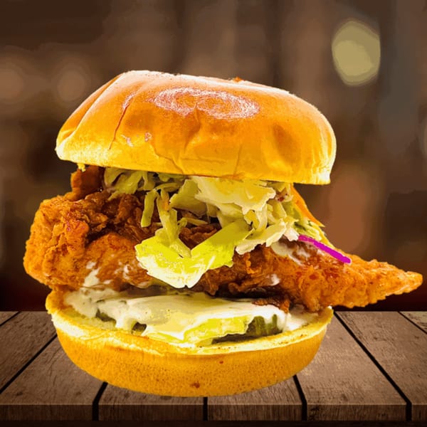 Five Star Chicken's fried chicken sandwich with lettuce, pickles, and sauce on a bun.
